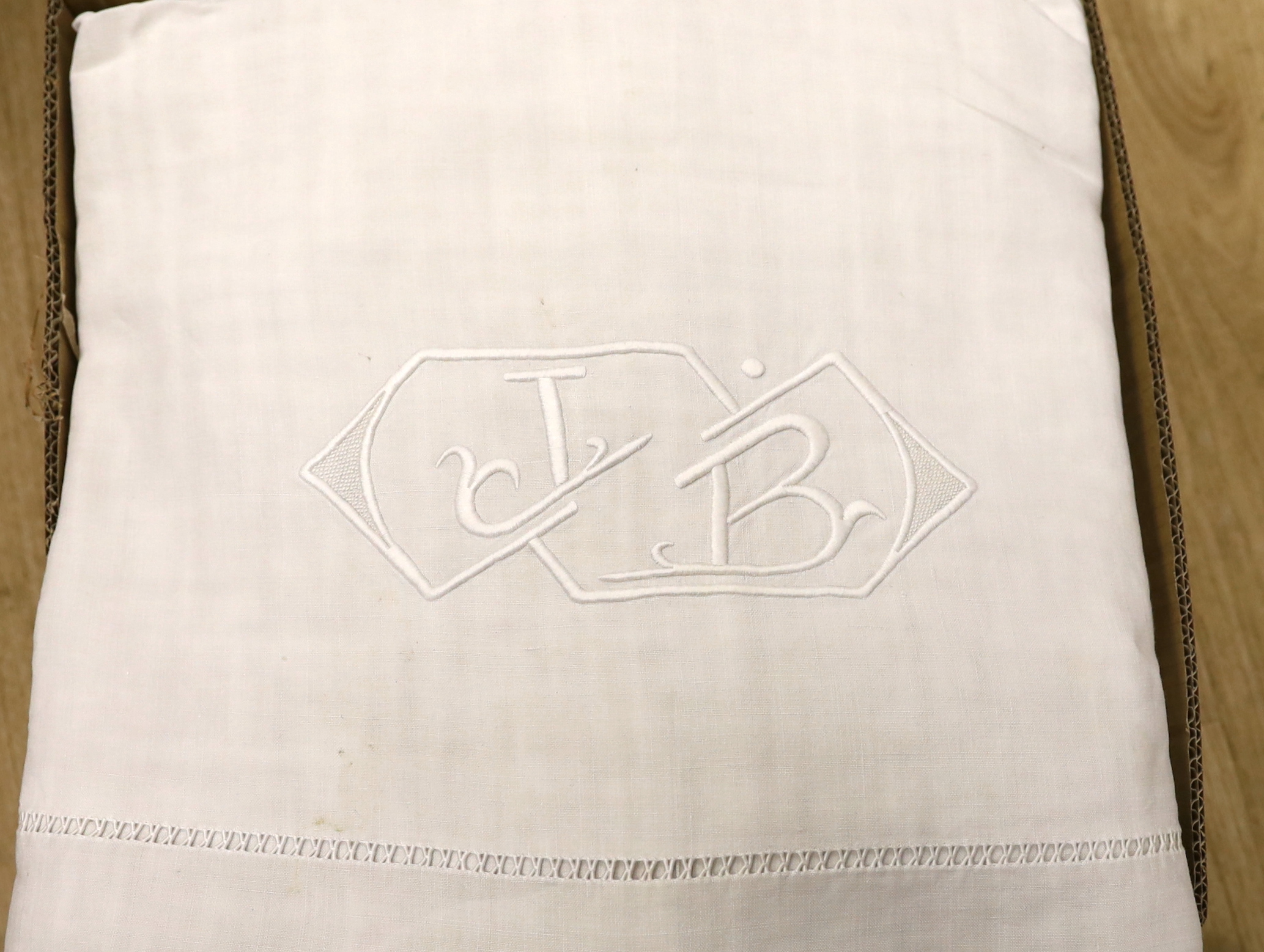 A collection of eight French provincial coarse linen sheets with embroidered and monogrammed turnbacks